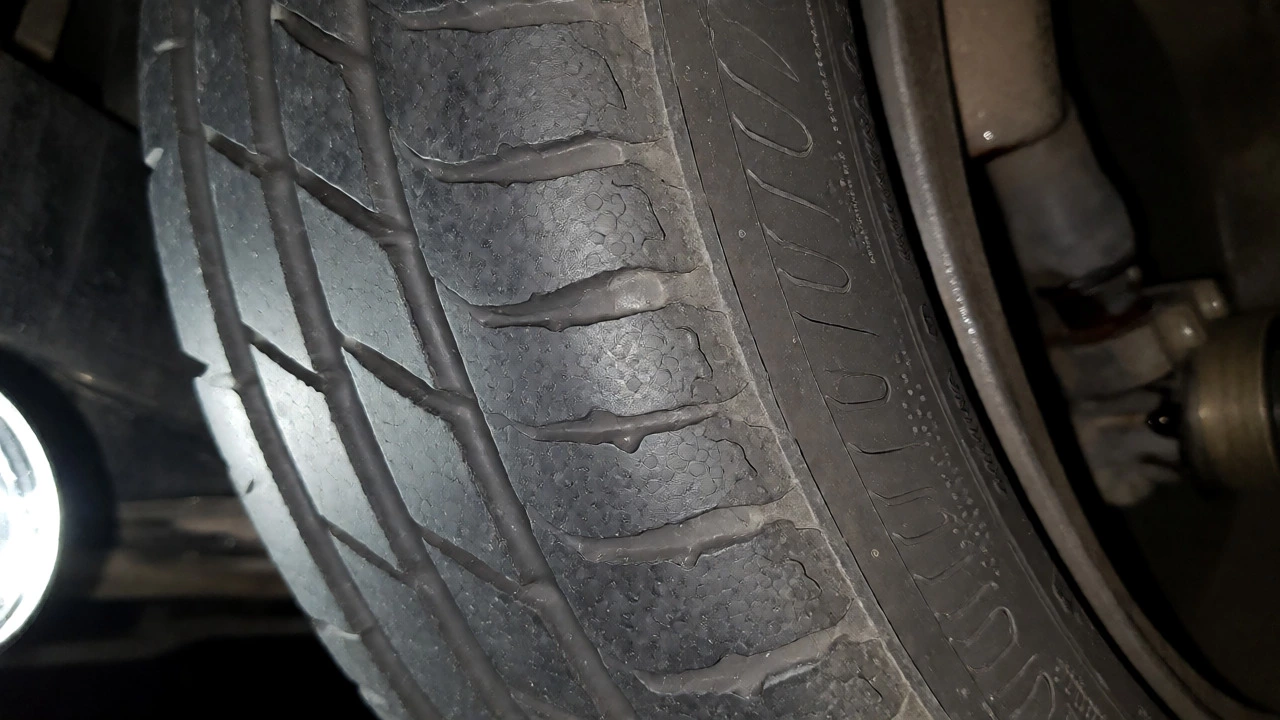 Close-up of a tire with cupping wear indicating bad shocks